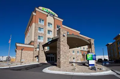 a front view of a hotel with a building at Holiday Inn Express and Suites Denver East Peoria Street by IHG in Denver