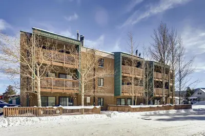 an apartment building with a balcony in the snow at Ten Mile Creek 304 condo in Frisco