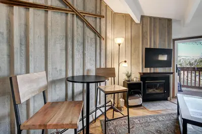 a room with a table and chairs and a fireplace at Ten Mile Creek 304 condo in Frisco