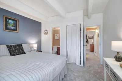 a bedroom with a white bed and a hallway at Ten Mile Creek 304 condo in Frisco