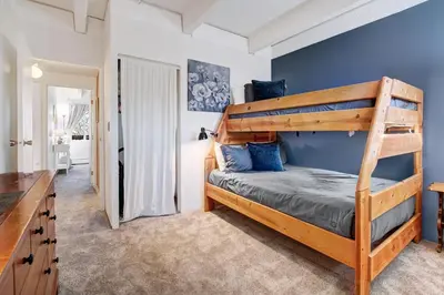 a bedroom with a bunk bed with blue walls at Ten Mile Creek 304 condo in Frisco