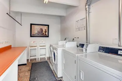 a white laundry room with a washer and dryer at Ten Mile Creek 304 condo in Frisco
