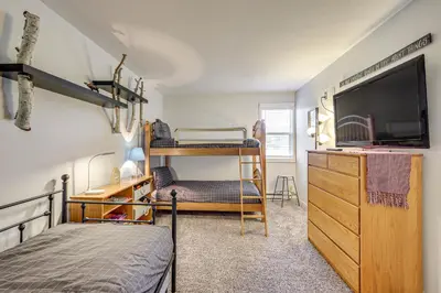 a bedroom with two bunk beds and a tv at 3 Mi to Winter Park Resort Cozy Ski Condo in Winter Park