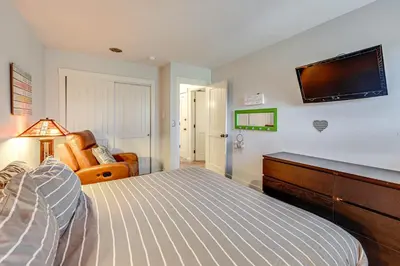 a bedroom with a bed and a television on the wall at 3 Mi to Winter Park Resort Cozy Ski Condo in Winter Park