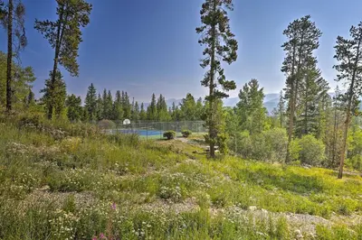 a garden with a pool in the middle of a forest at 3 Mi to Winter Park Resort Cozy Ski Condo in Winter Park