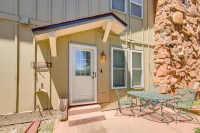 a table and chairs outside of a house with a door at 3 Mi to Winter Park Resort Cozy Ski Condo in Winter Park