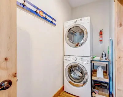 a laundry room with a washer and dryer at Mountain Willow at Grand Park home in Fraser