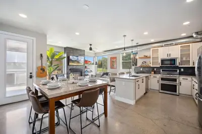 a kitchen with a table and chairs in a room at Swanky Townhome near Old Town, Breweries & River! in Fort Collins