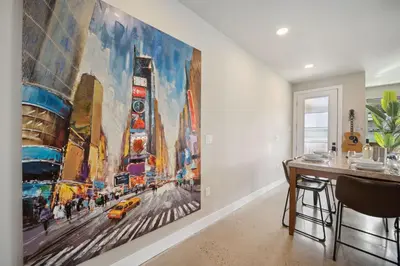 a large painting on the wall in a room at Swanky Townhome near Old Town, Breweries & River! in Fort Collins