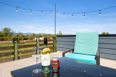 a bottle of wine and a glass on a table at Swanky Townhome near Old Town, Breweries & River! in Fort Collins