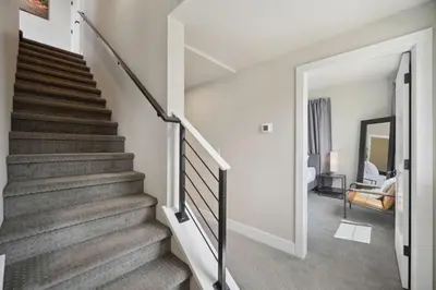 a staircase in a home with a stair case at Swanky Townhome near Old Town, Breweries & River! in Fort Collins