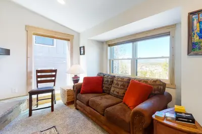 a living room with a couch and a chair at Modern Fraser Mountain Home in Fraser