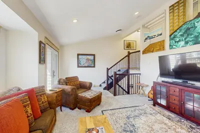 a living room with a couch and a television at Modern Fraser Mountain Home in Fraser
