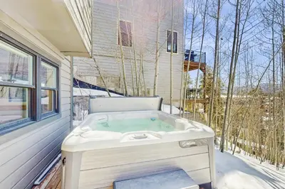 a bath tub sitting next to a window at Modern Fraser Mountain Home in Fraser