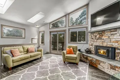 a living room with a couch and a fireplace at Royal Rays in Frisco
