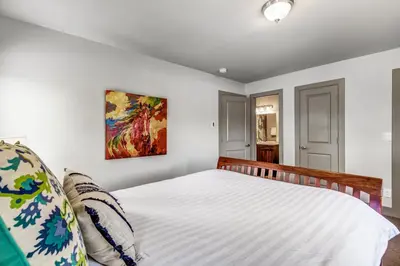 a bedroom with a bed and a painting on the wall at Royal Rays in Frisco