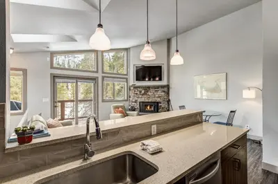 a kitchen with a sink and a fireplace at Royal Rays in Frisco