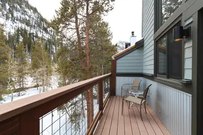 a balcony with a table and chairs on a house at Royal Rays in Frisco