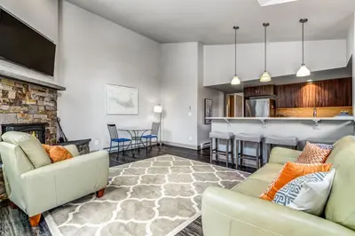 a living room with two couches and a fireplace at Royal Rays in Frisco