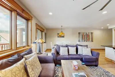 a living room with couches and a table at Mountain Retreat on 1st in Frisco