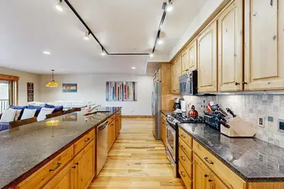 a kitchen with wooden cabinets and a counter top at Mountain Retreat on 1st in Frisco