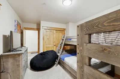 a bedroom with two bunk beds with a ladder at Mountain Retreat on 1st in Frisco
