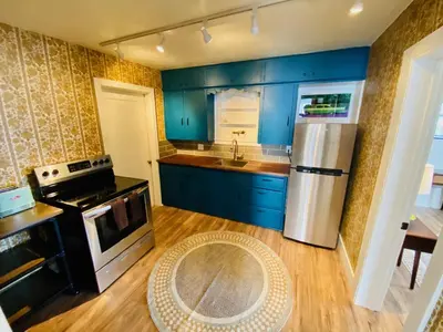 a kitchen with blue cabinets and a stainless steel refrigerator at A-Lodge Lyons in Lyons