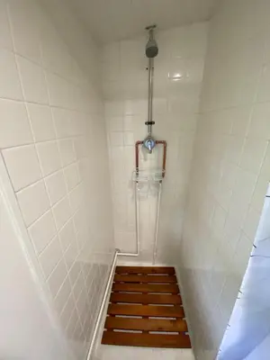 a bathroom with a shower with a stair hesitate at A-Lodge Lyons in Lyons