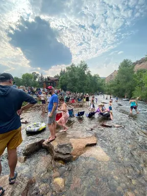 a group of people in the water at a beach at A-Lodge Lyons in Lyons