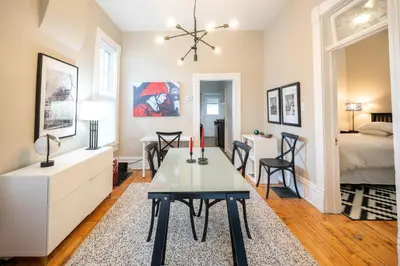 a living room with a table and a bedroom at 2360 Glenarm Place in Denver