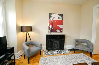 a living room with two chairs and a fireplace at 2360 Glenarm Place in Denver