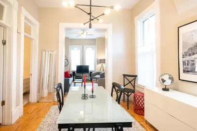 a dining room and living room with a table and chairs at 2360 Glenarm Place in Denver