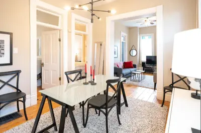 a dining room and living room with a table and chairs at 2360 Glenarm Place in Denver