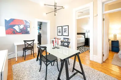 a dining room and living room with a table and chairs at 2360 Glenarm Place in Denver