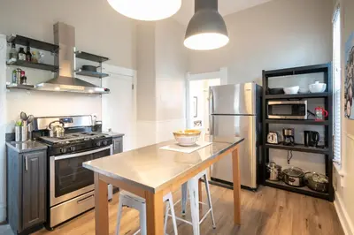 a kitchen with a table and a stainless steel refrigerator at 2360 Glenarm Place in Denver