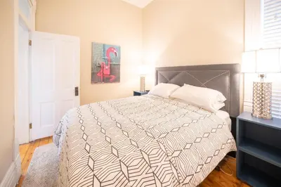a bedroom with a bed with a white comforter at 2360 Glenarm Place in Denver