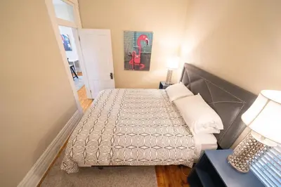 a small bedroom with two beds and a table and lamp at 2360 Glenarm Place in Denver