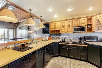 a large kitchen with wooden cabinets and appliances at Dillon Dreamscape in Dillon