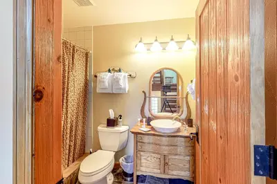 a bathroom with a toilet and a sink and a mirror at Dillon Dreamscape in Dillon