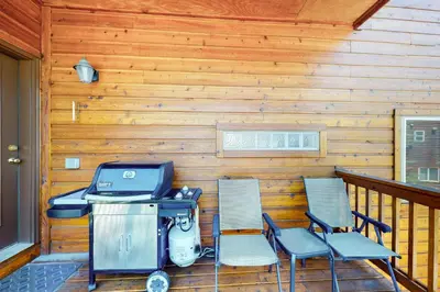a patio with two chairs and a grill on a porch at Dillon Dreamscape in Dillon