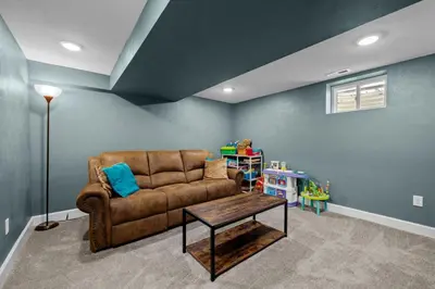 a living room with a brown couch and a table at 5632 Field St in Arvada