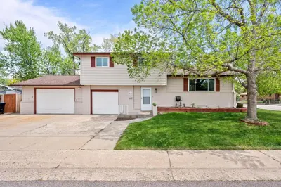 a white house with a tree in the yard at 5632 Field St in Arvada