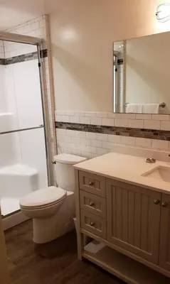 a bathroom with a toilet and a sink and a mirror at Clear Creek Inn in Georgetown