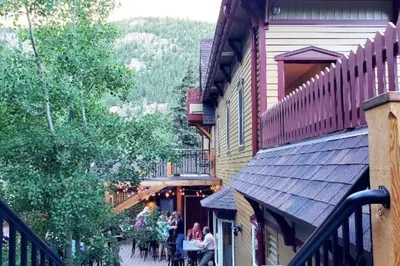 a group of people sitting at tables outside a building at Clear Creek Inn in Georgetown