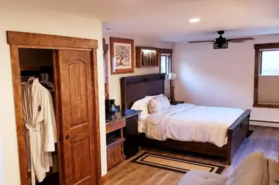 a bedroom with a bed and a couch at Clear Creek Inn in Georgetown