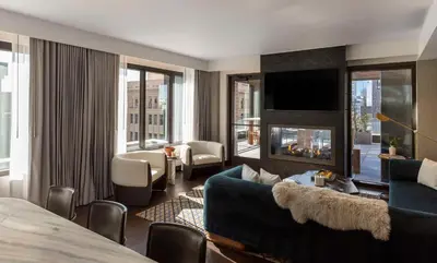a hotel room with a couch and a fireplace at Thompson Denver, by Hyatt in Denver