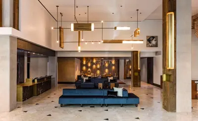 a lobby of a hotel with a blue couch at Thompson Denver, by Hyatt in Denver