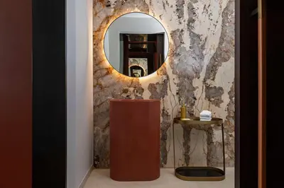 a bathroom with a vanity and a mirror at Thompson Denver, by Hyatt in Denver