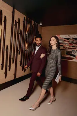 a man and a woman standing next to a wall of knives at Thompson Denver, by Hyatt in Denver