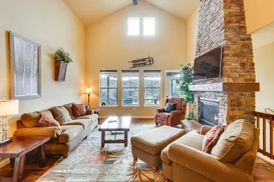 a living room with couches and a fireplace at Spacious Granby Home with Views Less Than 2 Mi to Ski and Golf in Granby